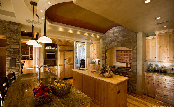 Designer kitchen with wood, stone and hanging lights